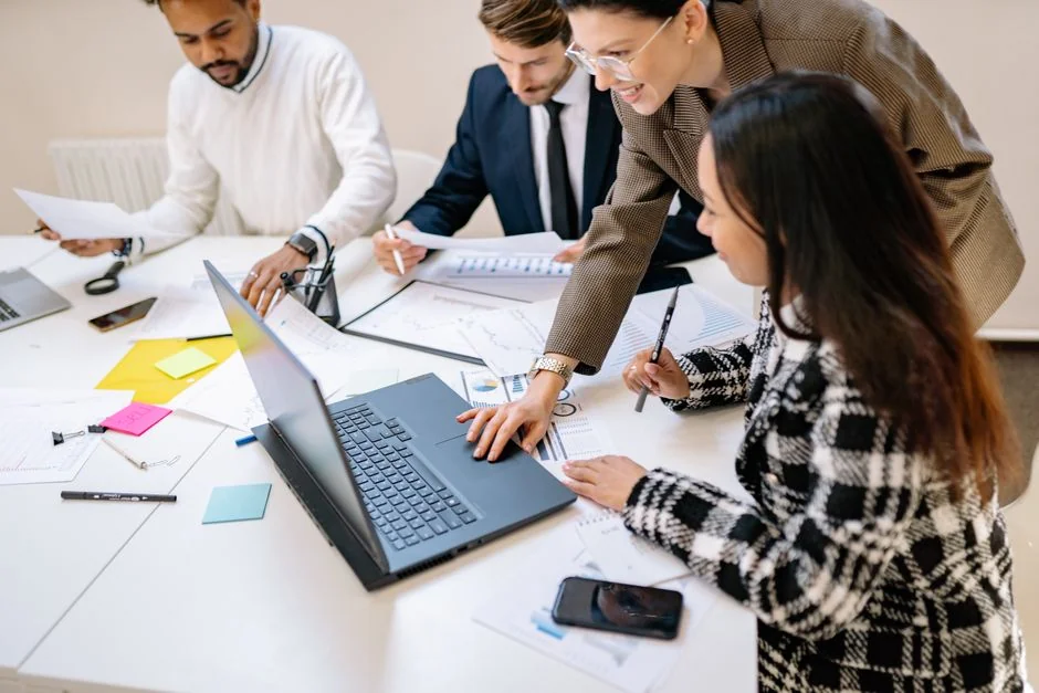 Group of business professionals working together in an office environment.